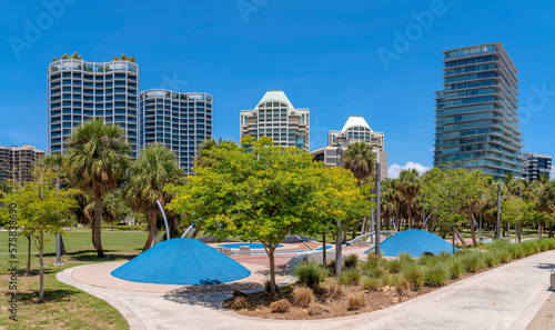 Regatta Park in Miami Beach Florida against apartments and sky on a sunny day. Public recreation area in the city with walkways and trees for visitors and tourists.