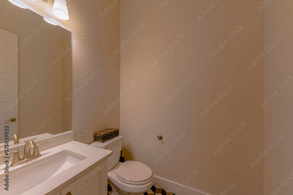 Small bathroom with cream walls and rectangular modern sink. There is a