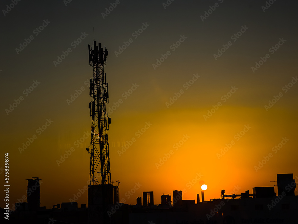 Signal tower silhouetted against the sky at sunset