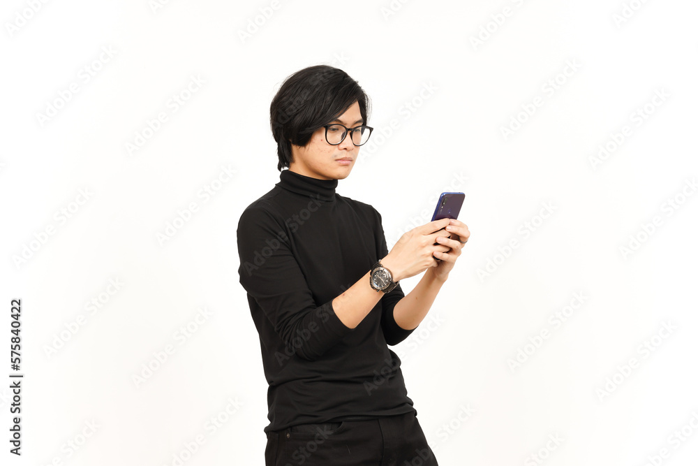 Holding and Using Smartphone with angry face Of Handsome Asian Man Isolated On White Background Holding and Using Smartphone with angry face Of Handsome Asian Man Isolated On White Background
