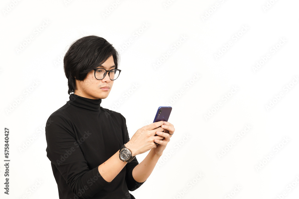 Holding and Using Smartphone with angry face Of Handsome Asian Man Isolated On White Background Holding and Using Smartphone with angry face Of Handsome Asian Man Isolated On White Background