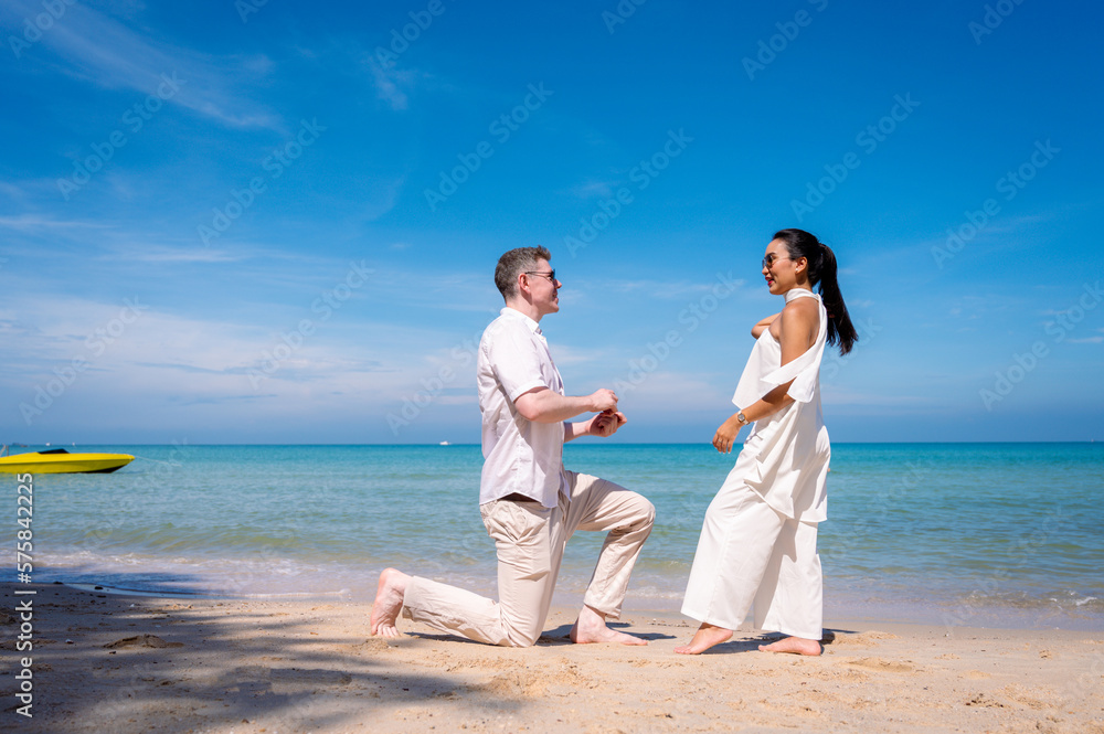 happy couple jumping on the beach romantic moments in honeymoon trip. happy couple jumping on the beach romantic moments in honeymoon trip.