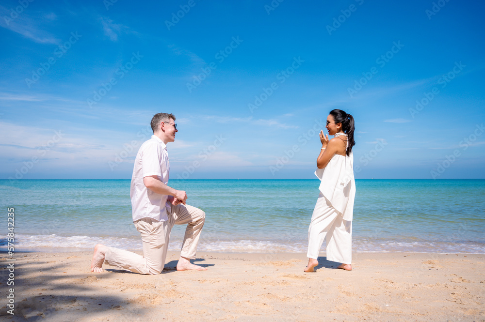 happy couple jumping on the beach romantic moments in honeymoon trip. happy couple jumping on the beach romantic moments in honeymoon trip.