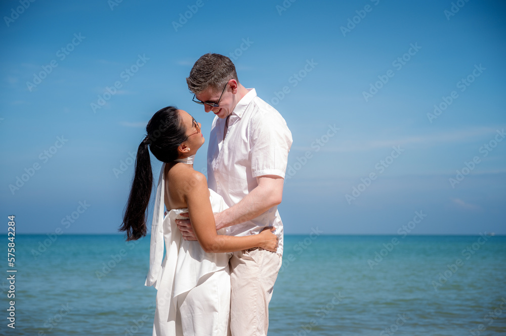 happy couple jumping on the beach romantic moments in honeymoon trip. happy couple jumping on the beach romantic moments in honeymoon trip.