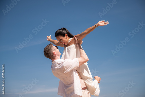 happy couple jumping on the beach romantic moments in honeymoon trip.