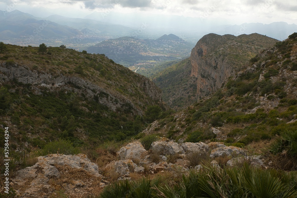 View of Montgó mountain in Spain with its cliffy, green surroundings overlooking the valley of Oliva.