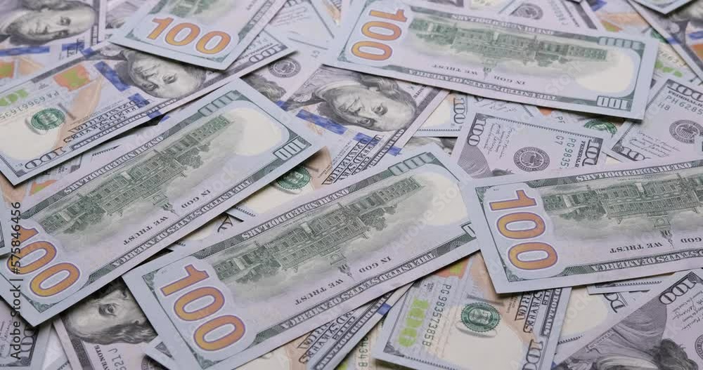 Cash USD money background - One hundred dollar banknotes rotate in close up macro view Cash USD money background - One hundred dollar banknotes rotate in close up macro view