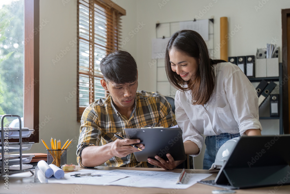 Architecture engineering teamwork meeting at workplace to plan drawing a new blueprint busy working for apartment building Architecture engineering teamwork meeting at workplace to plan drawing a new blueprint busy working for apartment building
