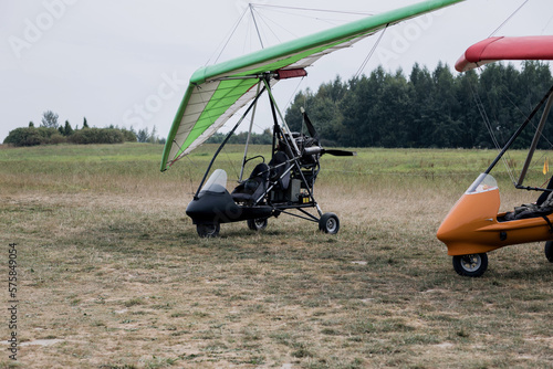 Powered hang glider at a field airport.
