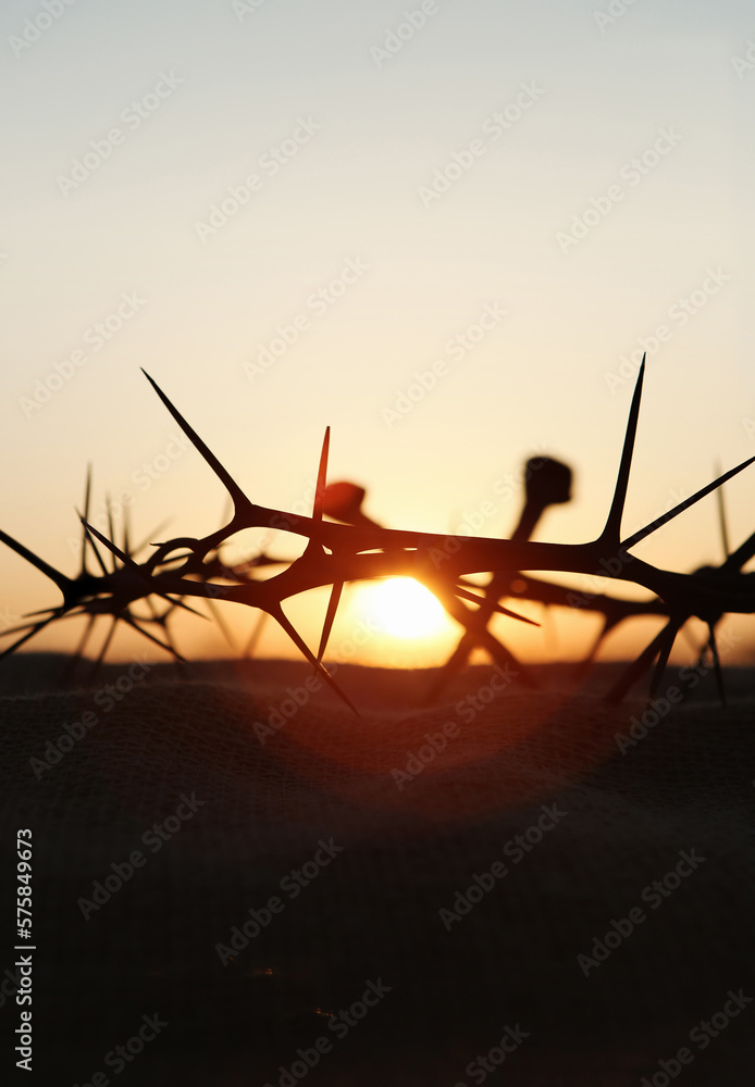 The cross, crown of thorns, nails and red sunset symbolizing the sacrifice and suffering of Jesus Christ, Passion Week and Lent concept
 - obrazy, fototapety, plakaty 