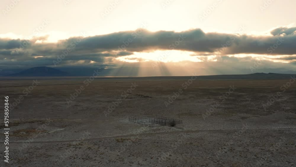 Morning sunbeams behind rustic cattle corral in desert ranch landscape Morning sunbeams behind rustic cattle corral in desert ranch landscape