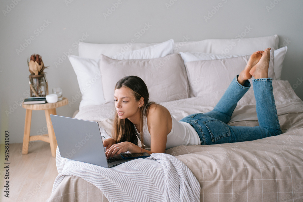 A healthy young brunette woman girl in white underwear checking her email  facebook online dating on laptop in bedroom at home UK Stock Photo - Alamy