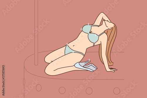 Girl in lingerie dances striptease on stage entertaining visitors to stag party