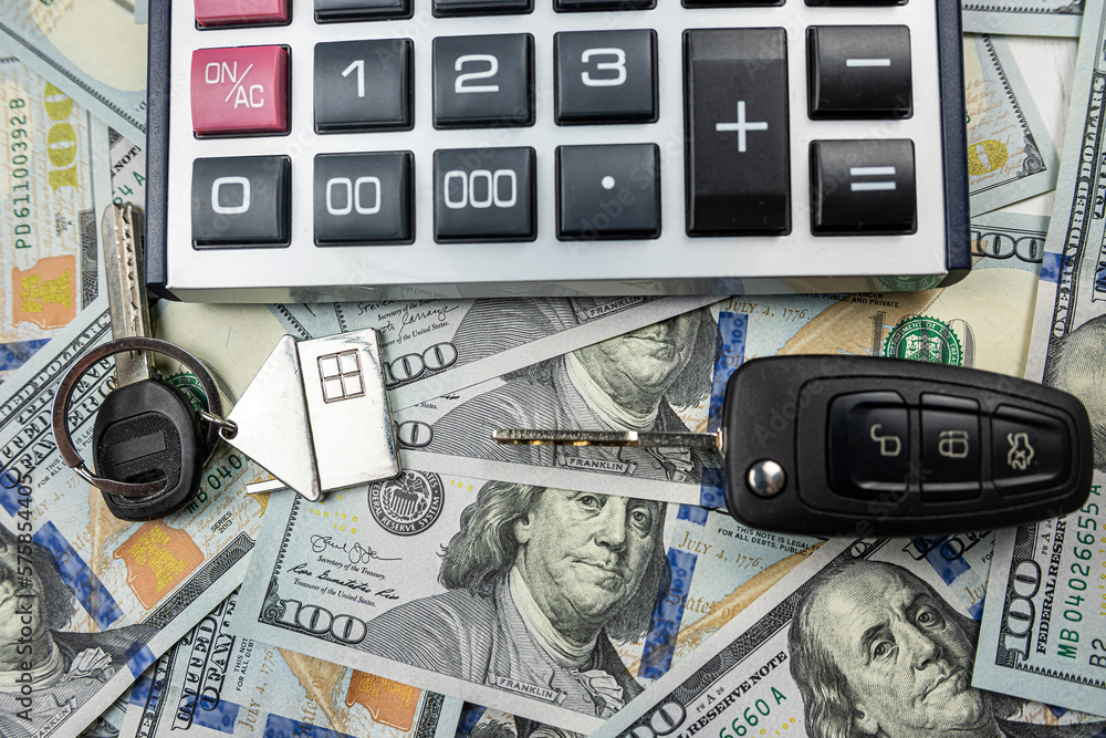 keys of house and car with calculator on us dollar money keys of house and car with calculator on us dollar money