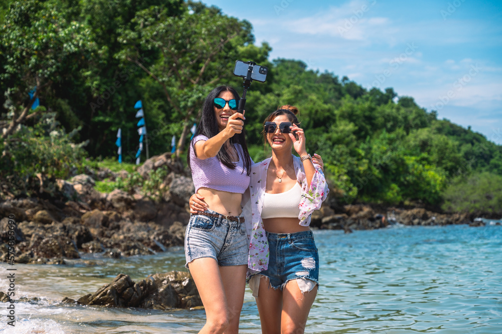 Lifestyle women and friends having fun and enjoying being themselves.Girls smiling and selfie with friends by the sea on the tropical island.Concept summer travel. Lifestyle women and friends having fun and enjoying being themselves.Girls smiling and selfie with friends by the sea on the tropical island.Concept summer travel.