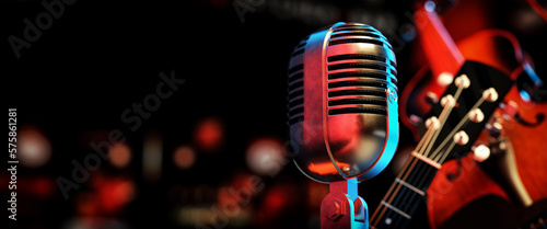 Close-up of a classic silver microphone and a guitar, violin