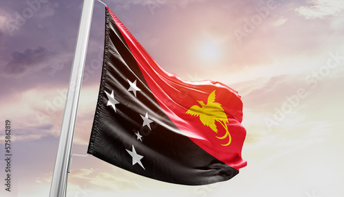 Obraz na plátně Waving Flag of Papua New Guinea in Blue Sky