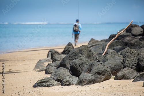Angler Jonathan Jones hikes the beaches of Samoa in search of fly fishing waters. photo