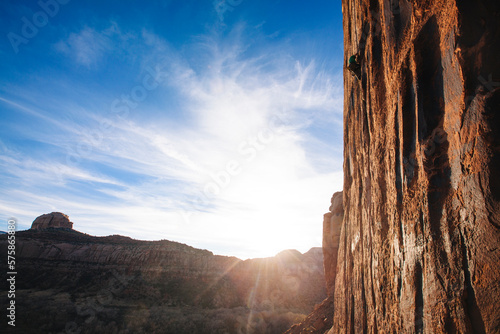 A man enjoying a beauitful fall eveing of rock climing in Indian Creek, Utah photo