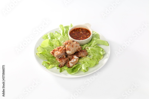 ribs sliced on a white plate with a green salad
