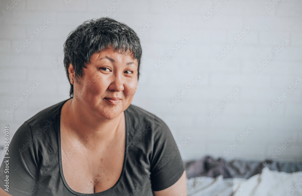 Asian woman of forty with a short haircut on a white background Asian woman of forty with a short haircut on a white background