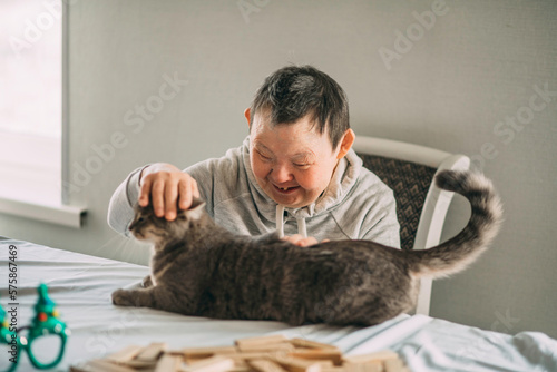 Εκτύπωση καμβά Elderly woman with down syndrome smiling and petting her mature domestic animal