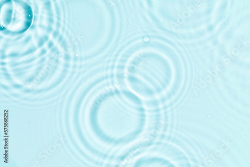 Abstract water, cosmetic background with waves and ripples and spherical granules. Concept of therapeutic moisturizing cosmetics