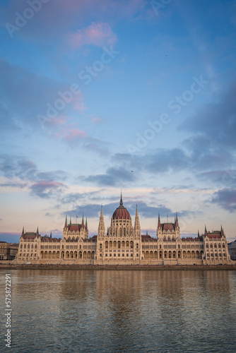 Budapest Parliament from across Danube river, Hungary. Beautiful blue evening sky with pink clouds.