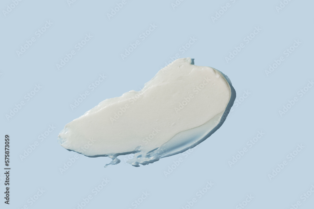 White cosmetic cream texture on blue background. Skin care product smear. Lotion, hair mask or other csmetic product texture with copy space - obrazy, fototapety, plakaty 