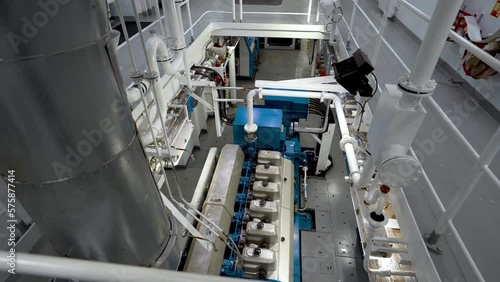 Main engine of vessel and exhaust pipe. Engine room inside