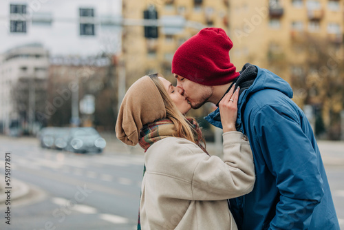 Romantic couple kissing each other at street photo