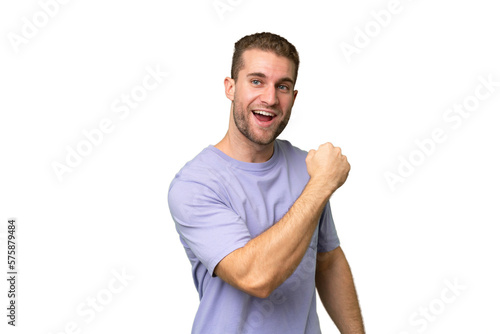 Young handsome caucasian man isolated on green chroma background celebrating a victory