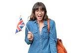 Young caucasian woman holding an United Kingdom flag over isolated background with surprise facial expression