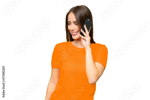 Young pretty caucasian woman over isolated background keeping a conversation with the mobile phone with someone photo
