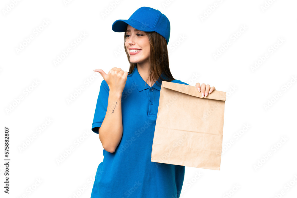 Young beautiful caucasian woman taking a bag of takeaway food over isolated background pointing to the side to present a product Young beautiful caucasian woman taking a bag of takeaway food over isolated background pointing to the side to present a product