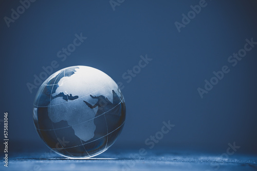 Blue world globe crystal glass on black background 