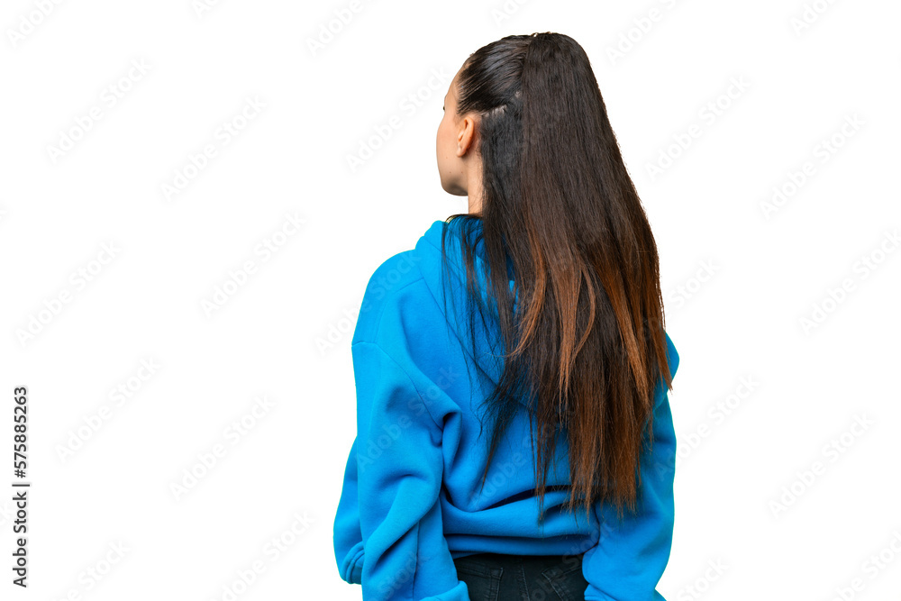 Young Arabian woman over isolated chroma key background in back position and looking back Young Arabian woman over isolated chroma key background in back position and looking back