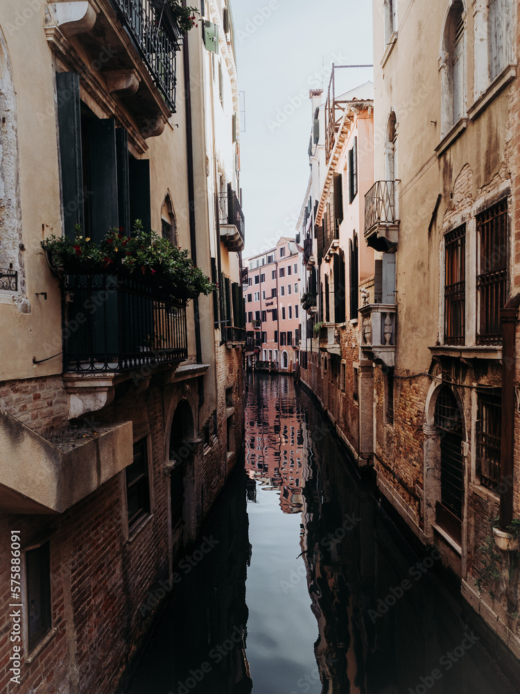 Narrow water canal in the city of Venice, Italy.