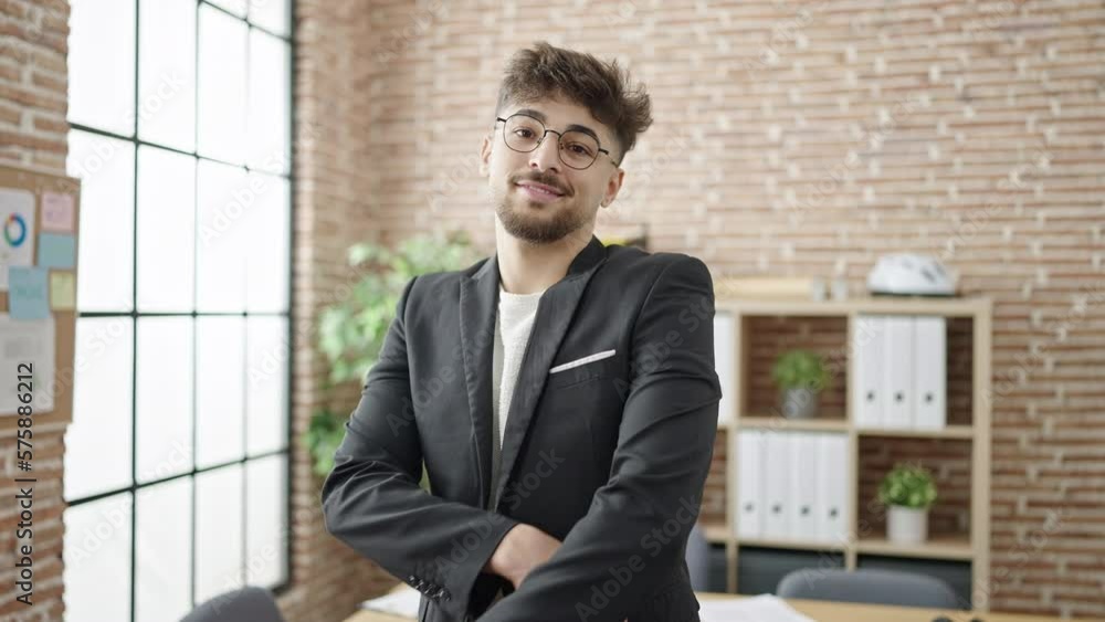 Young arab man business worker smiling confident standing with arms crossed gesture at office