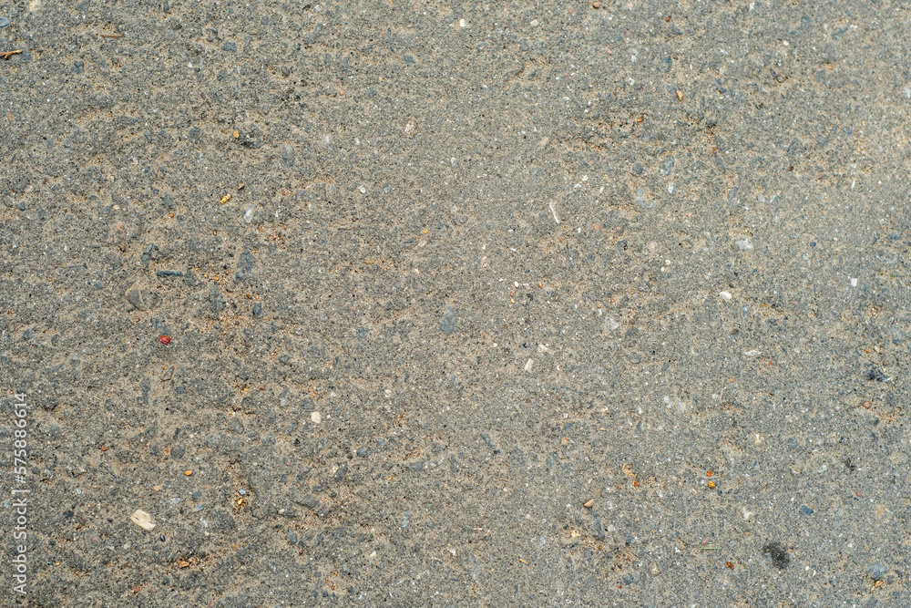 Background with old dusty asphalt interspersed with stone. The road from the asphalt-concrete mixture. Background with old dusty asphalt interspersed with stone. The road from the asphalt-concrete mixture.