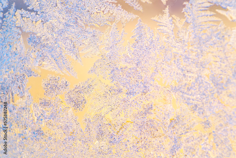 Frosty frost on a glass window. Close-up of ice patterns lightly blurred in soft focus.