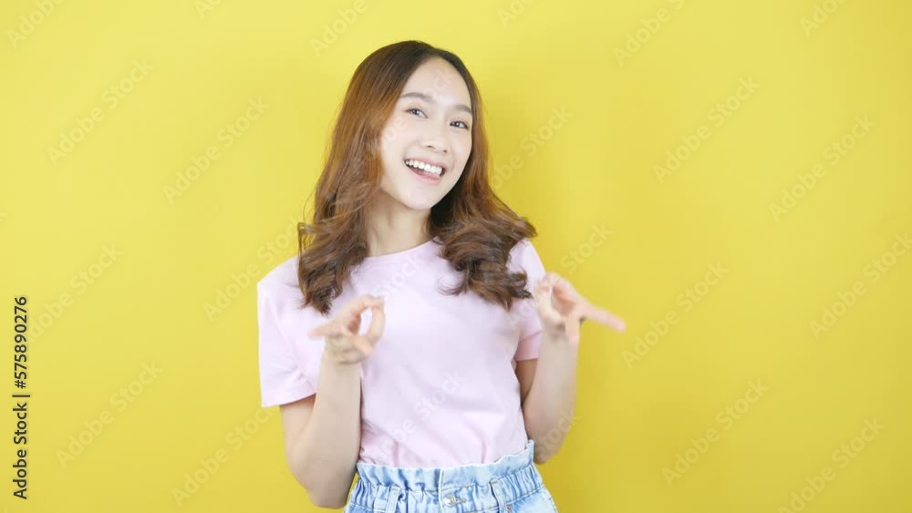 Woman showing Y2k pose. Asian retro fashion on yellow background. Woman showing Y2k pose. Asian retro fashion on yellow background.
