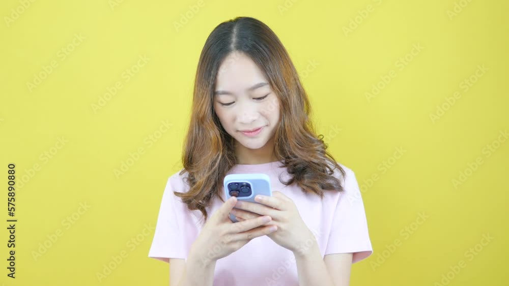 Asian woman chatting on mobile phone cute pink shirt Asian woman chatting on mobile phone cute pink shirt