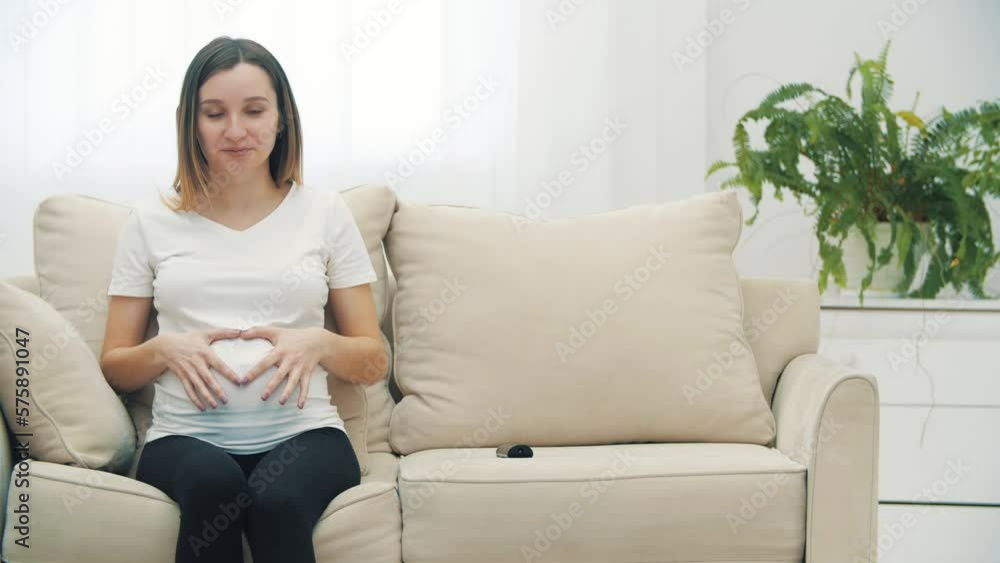4k video of pregnant woman making a heart shape with hands. 4k video of pregnant woman making a heart shape with hands.
