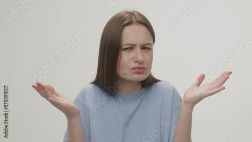 Wallpaper Mural Irritated woman throws up her hands, not understanding what is happening. Portrait of a confused brunette woman on a white background. Torontodigital.ca