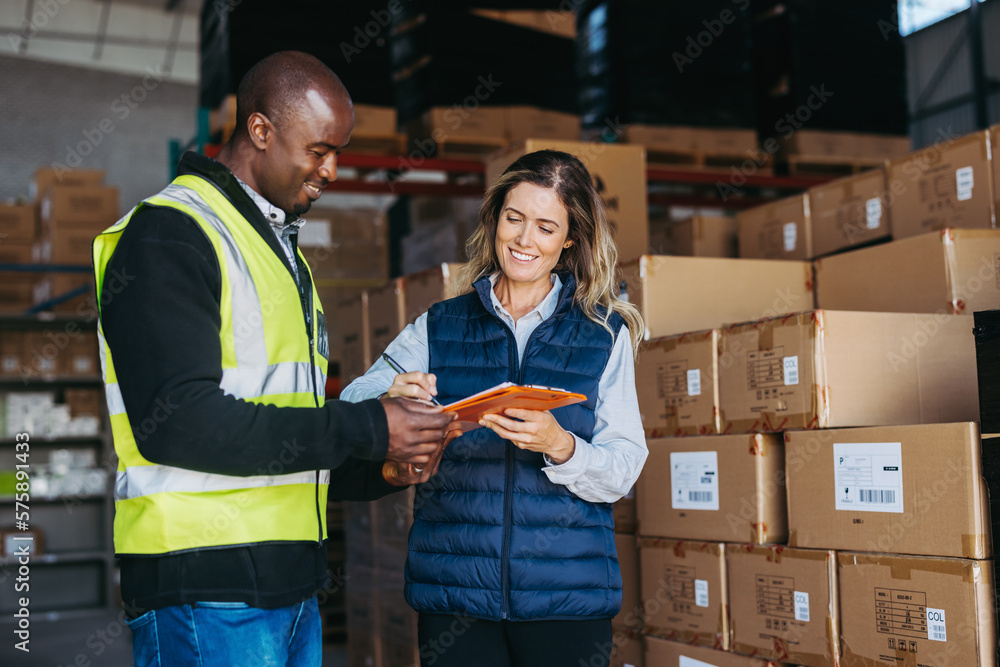 Happy warehouse manager signing a bill of lading after receiving goods