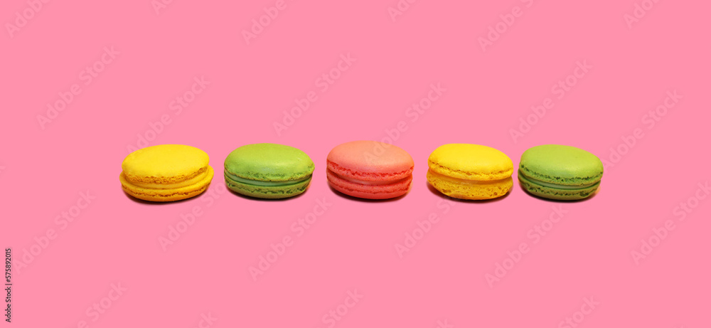 Multicolored sweet macaroons on pink background Multicolored sweet macaroons on pink background