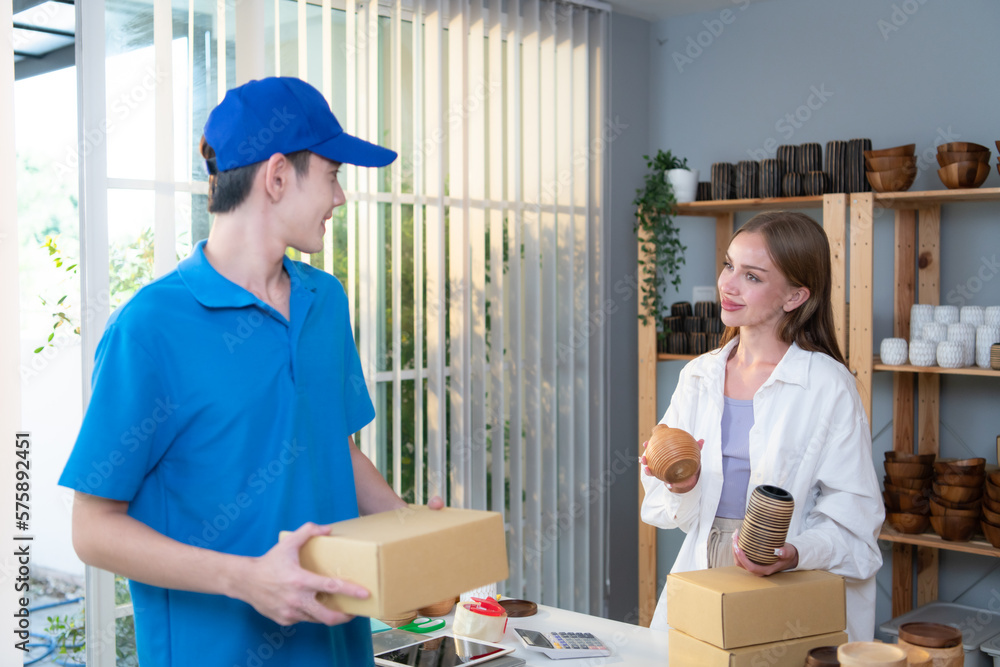 The delivery man brings the goods that the customer purchased and delivers them to the customer's home. The delivery man brings the goods that the customer purchased and delivers them to the customer's home.