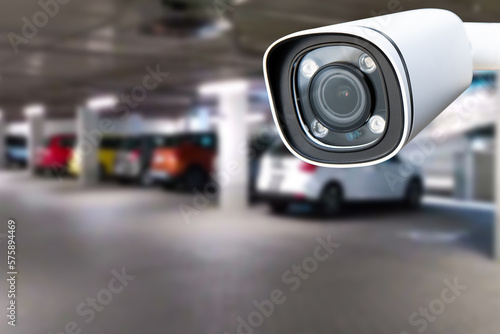 CCTV security camera on blur car parking. Copy space.