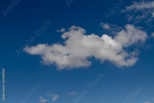 Blue sky with a few clouds background.